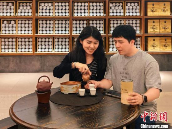 邓玮霖(左)与爱人张清品茗自家种植的白茶。受访者 供图